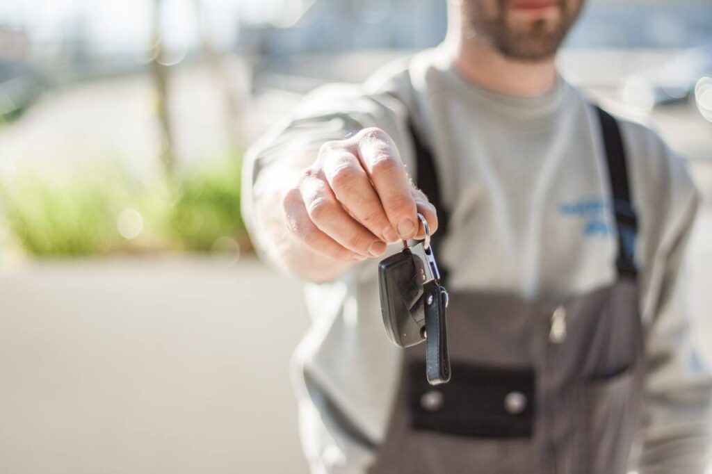 car mechanic holding a car key