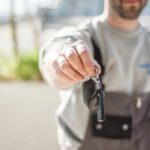 car mechanic holding a car key