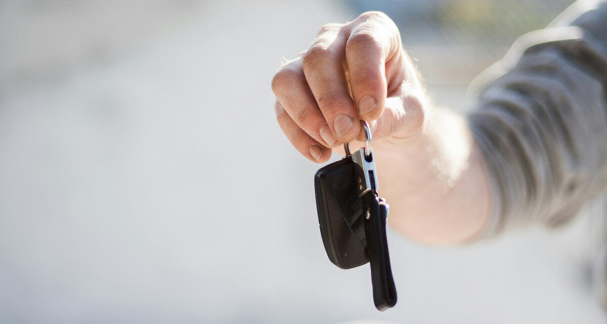 guy holding a car key